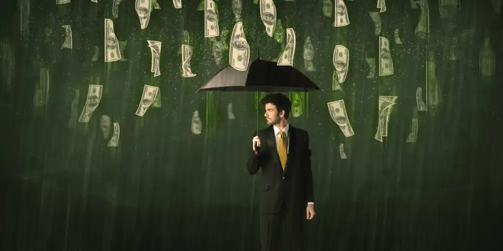 man holds an umbrella while money rains from the sky