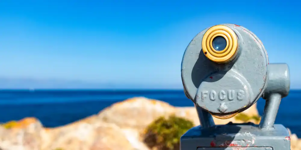 touristic telescope facing open sea